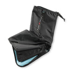 A second view of the black flexed elbow sleeve on white, tube form open at the lower cuff to show the light-blue lining.